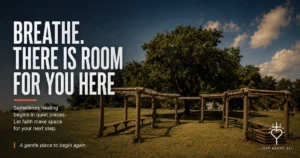 Outdoor church garden with shaded wooden seating beneath the words, “Breathe. There is room for you here,” and an invitation to let healing and faith unfold gently.